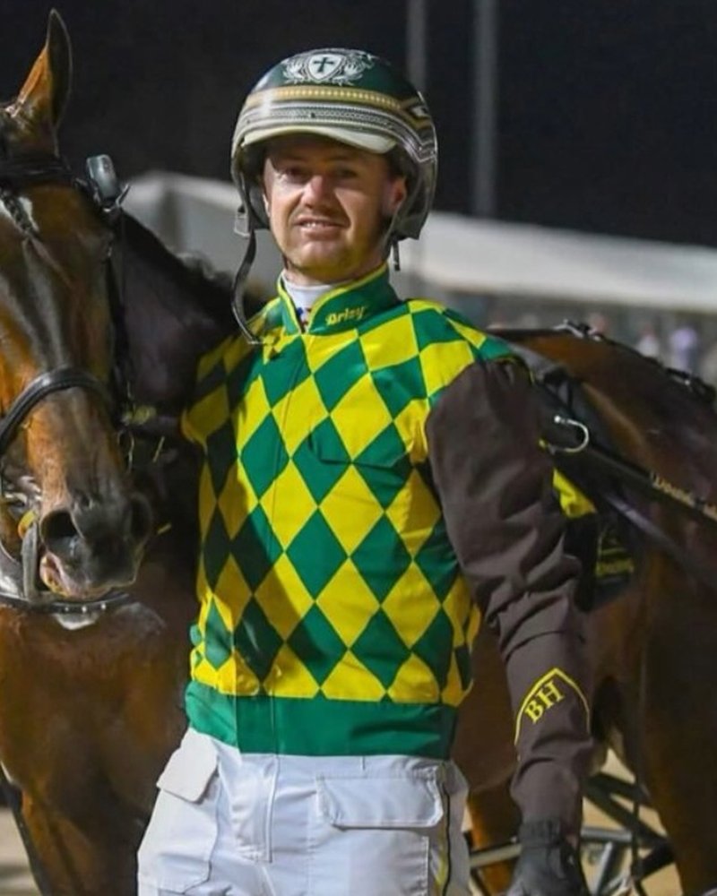 Brad Hewitt in racing silks with a horse